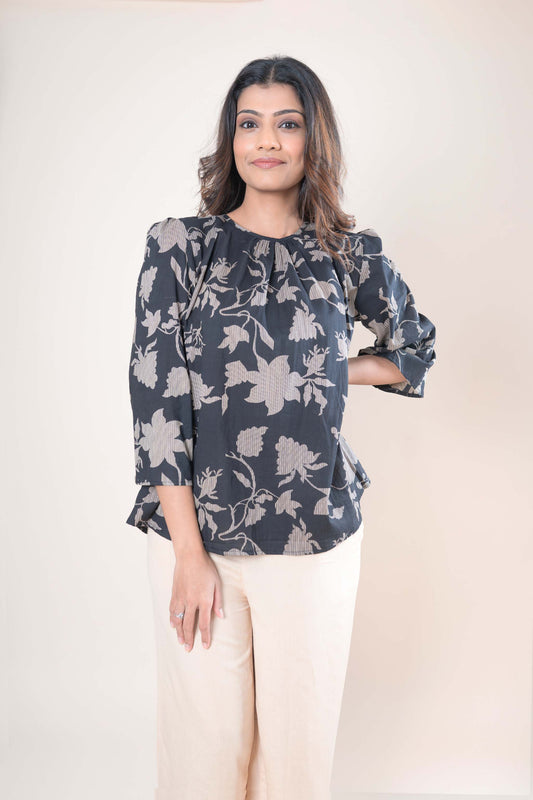 Woman wearing a floral blouse with a plain background