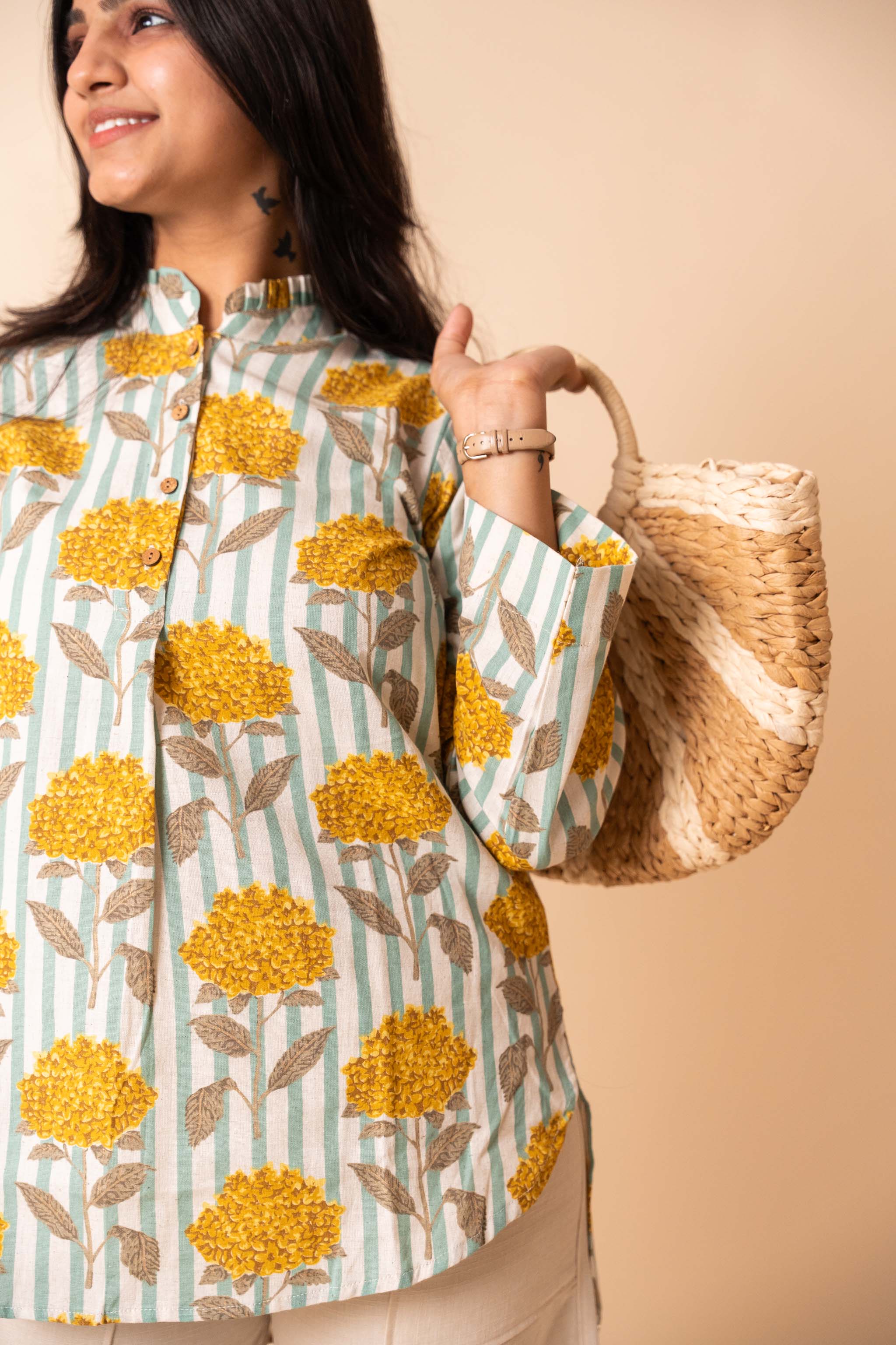 side profile of Yellow Floral Striped Top featuring soft pleats for office and workwear, women's tunic